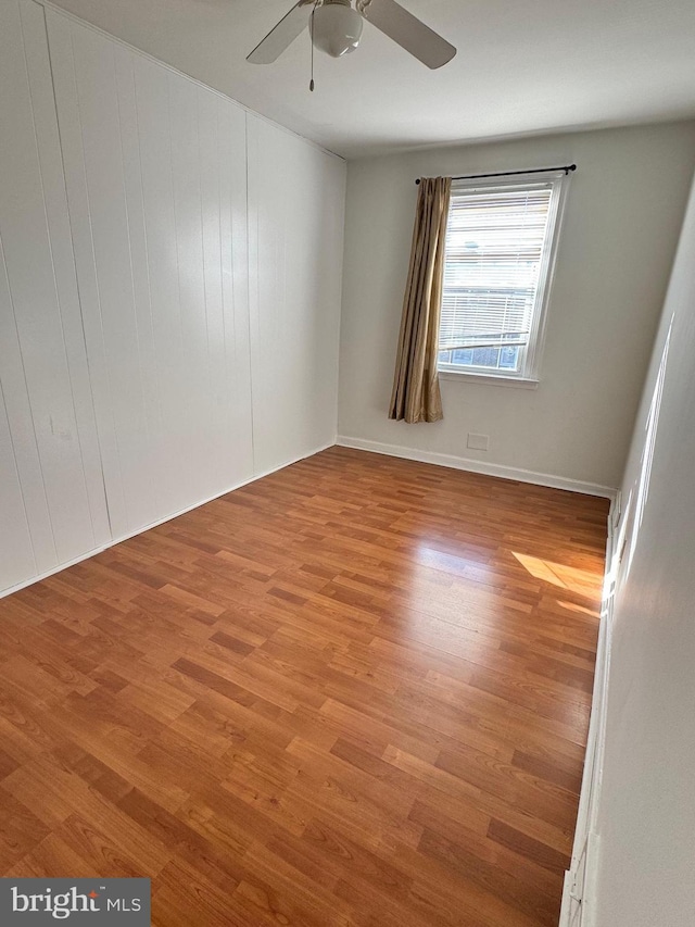 spare room with light hardwood / wood-style floors and ceiling fan