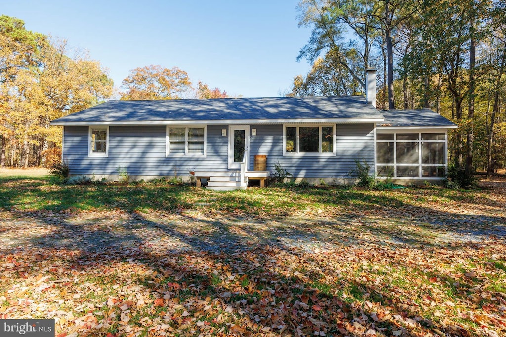 single story home featuring a sunroom