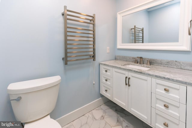 bathroom with vanity, toilet, and radiator heating unit