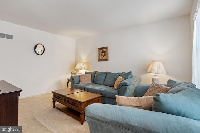 living room featuring light carpet, visible vents, and baseboards