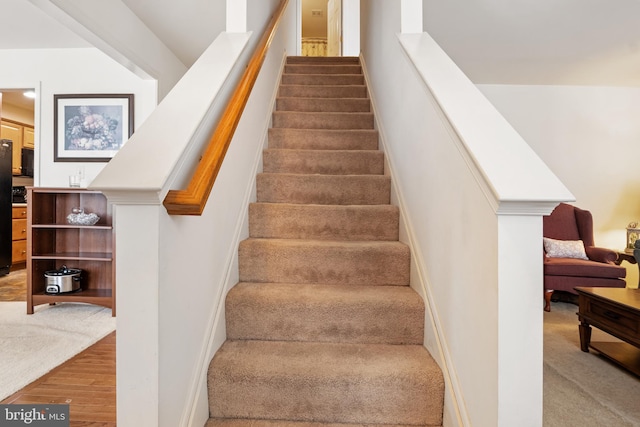 staircase featuring wood finished floors