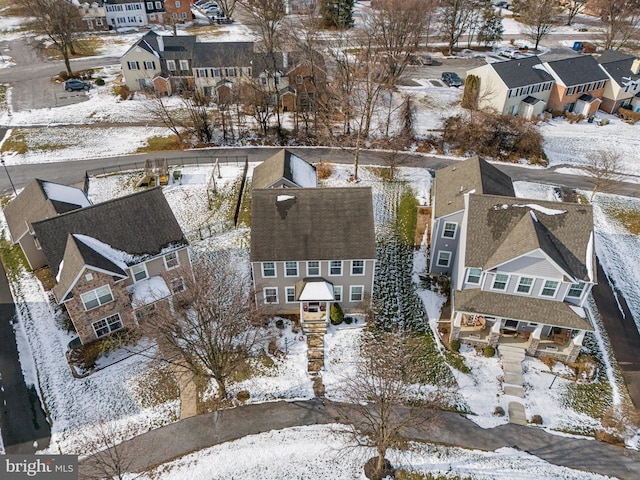 snowy aerial view featuring a residential view