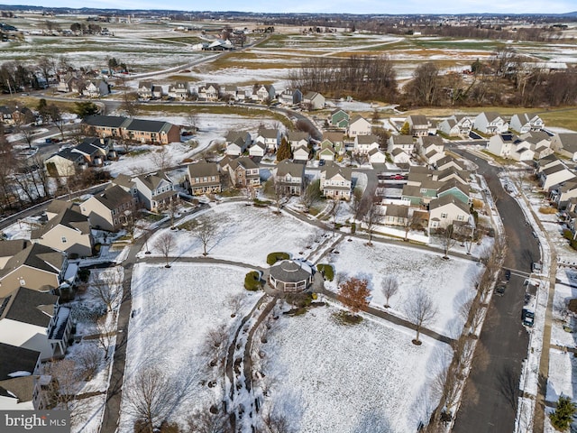 snowy aerial view with a residential view