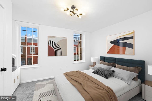 bedroom featuring carpet floors and a notable chandelier