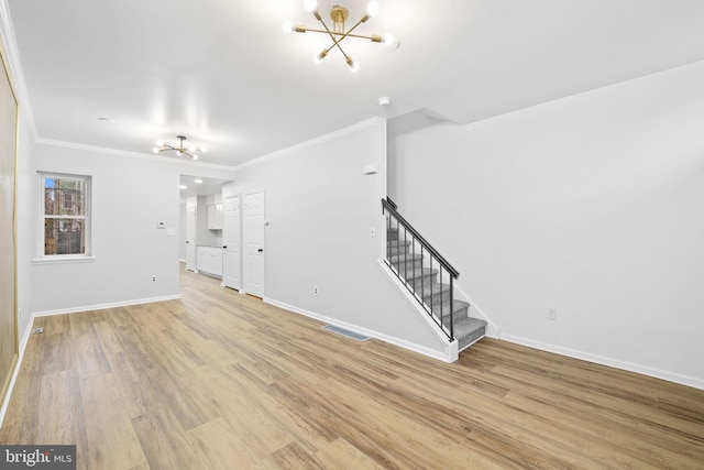 unfurnished living room featuring a notable chandelier, crown molding, and light hardwood / wood-style flooring