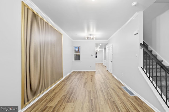 hall featuring light wood-type flooring and ornamental molding