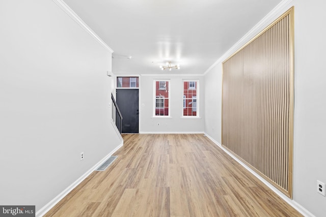 interior space featuring light hardwood / wood-style flooring and crown molding