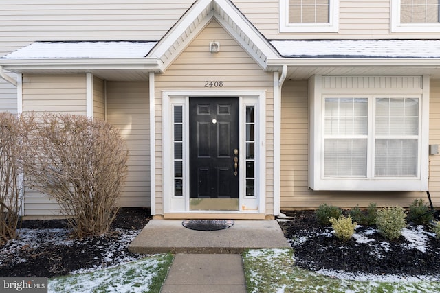 view of snow covered property entrance