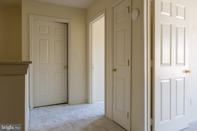 hallway featuring light carpet