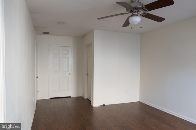 unfurnished room featuring ceiling fan and dark wood-type flooring