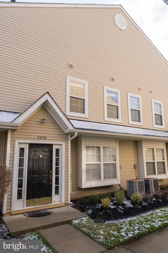 view of exterior entry featuring central AC unit