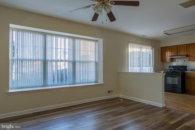 kitchen with ceiling fan, black range with gas cooktop, and dark wood-type flooring