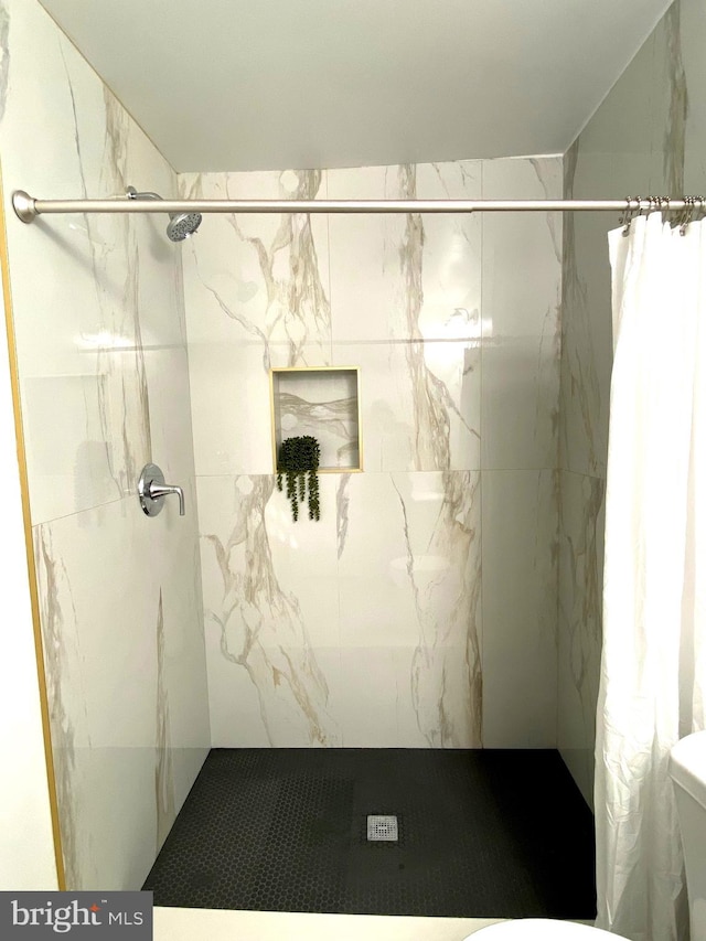 bathroom with toilet and walk in shower