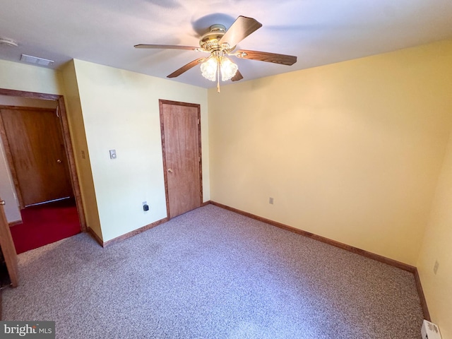 unfurnished bedroom with ceiling fan, a closet, light colored carpet, and a baseboard heating unit