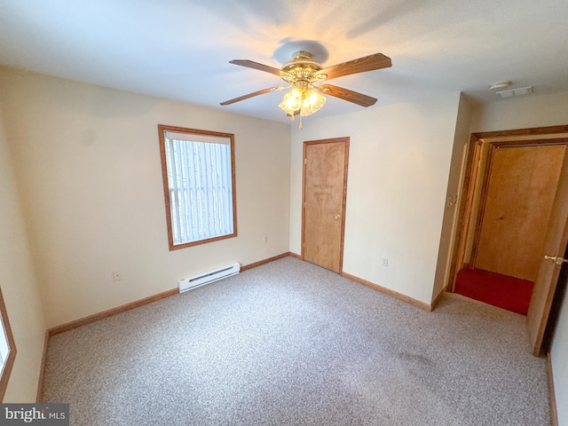 spare room featuring ceiling fan, light colored carpet, and a baseboard heating unit