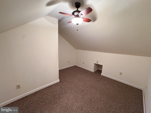 bonus room featuring ceiling fan, lofted ceiling, and dark colored carpet