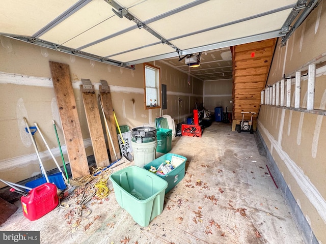 garage with electric panel and a garage door opener