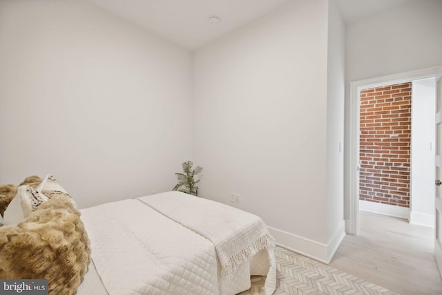 bedroom featuring light hardwood / wood-style floors and vaulted ceiling