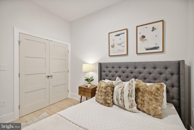 bedroom featuring a closet and light wood-type flooring