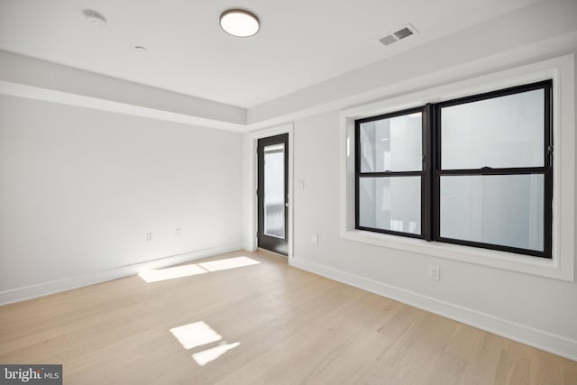 spare room featuring light hardwood / wood-style floors