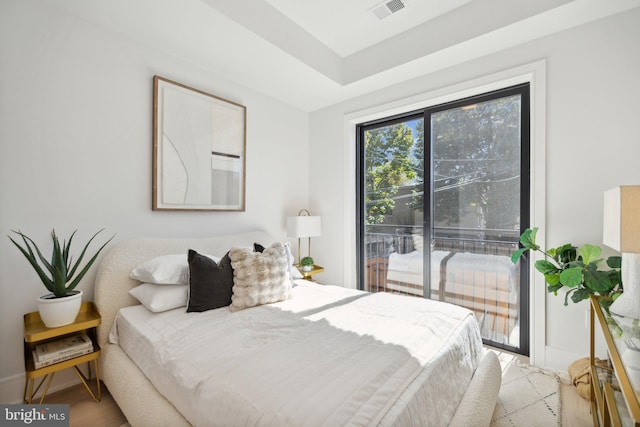 bedroom featuring access to exterior and wood-type flooring