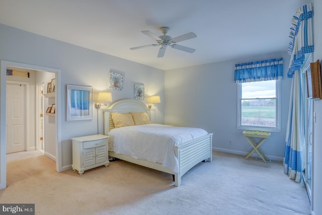 bedroom featuring light carpet and ceiling fan