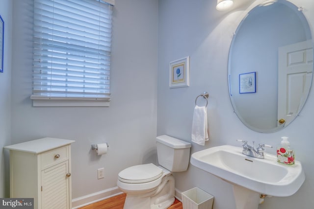 bathroom with sink, hardwood / wood-style floors, and toilet