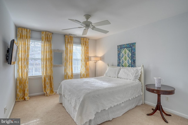 bedroom with ceiling fan and light colored carpet