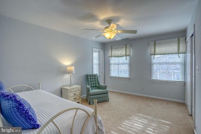 bedroom with ceiling fan and light colored carpet