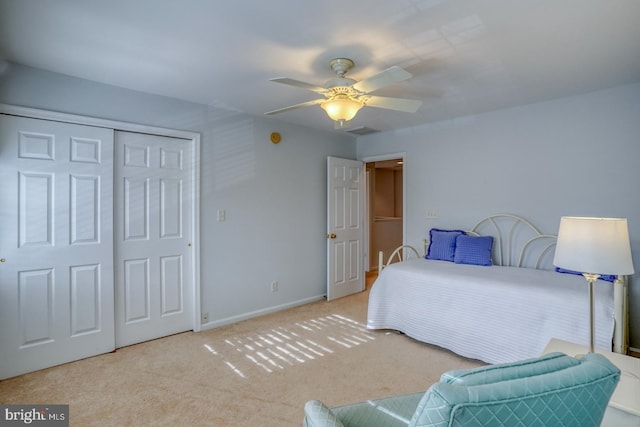 carpeted bedroom featuring a closet and ceiling fan