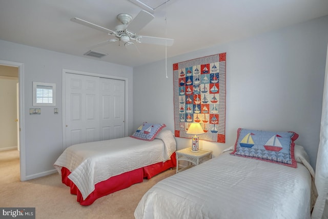 bedroom featuring ceiling fan, a closet, and light colored carpet