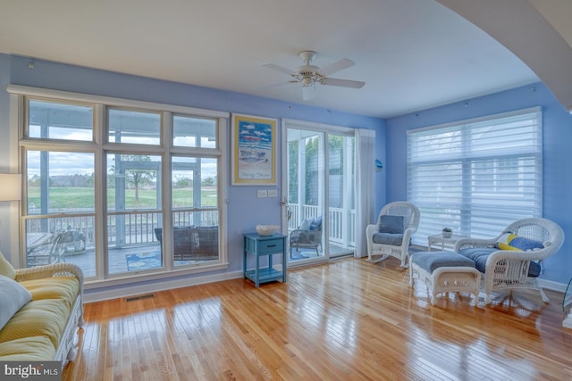 sitting room featuring ceiling fan and light wood-type flooring