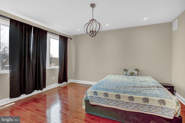 bedroom featuring a chandelier and hardwood / wood-style floors