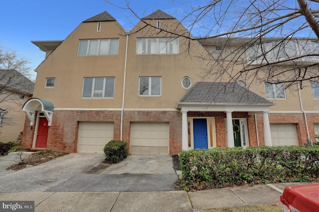 townhome / multi-family property featuring a garage