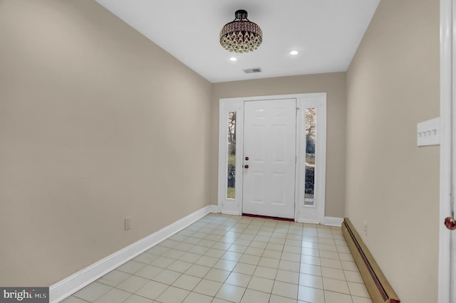 tiled entrance foyer with a baseboard radiator