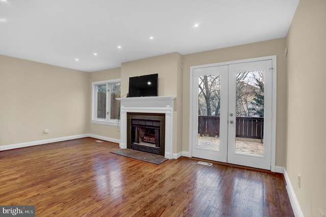 unfurnished living room with french doors and hardwood / wood-style flooring