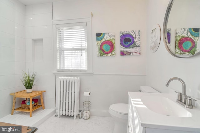 bathroom featuring radiator, vanity, and toilet