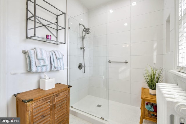 bathroom with tiled shower and radiator heating unit