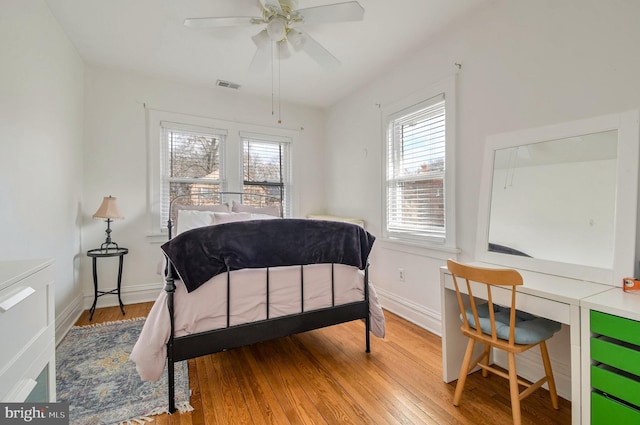 bedroom with light hardwood / wood-style floors and ceiling fan