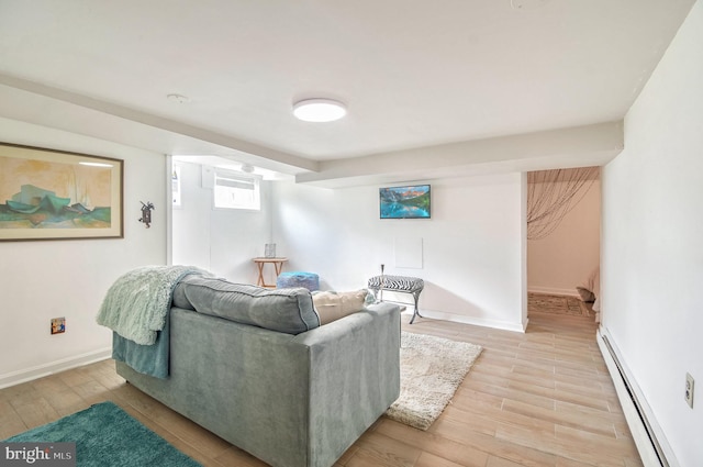 living room with light hardwood / wood-style flooring and a baseboard heating unit