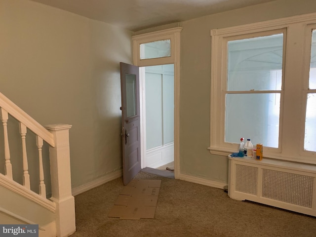 carpeted entryway featuring radiator