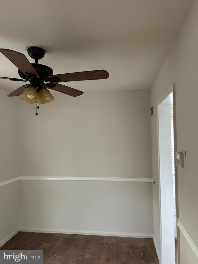 empty room featuring dark hardwood / wood-style floors and ceiling fan