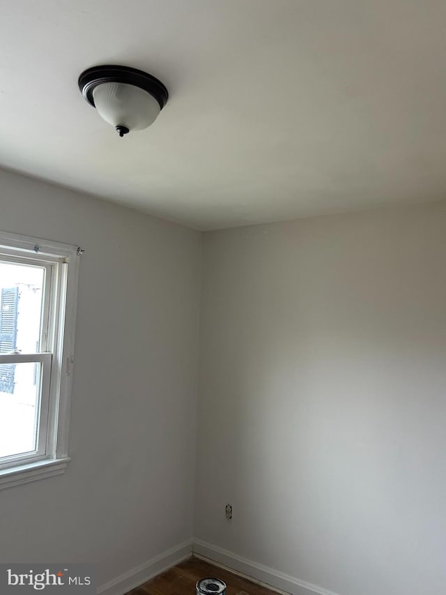 empty room with dark wood-type flooring