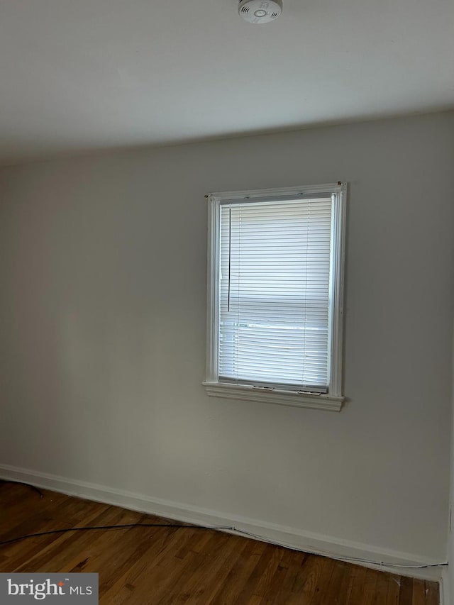 unfurnished room featuring hardwood / wood-style flooring