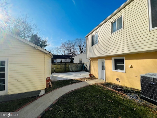 view of yard with central AC unit and a patio