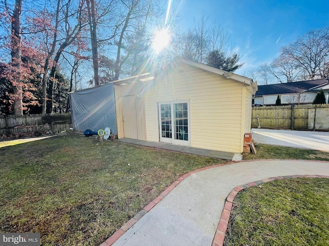 view of side of property featuring a yard and a patio