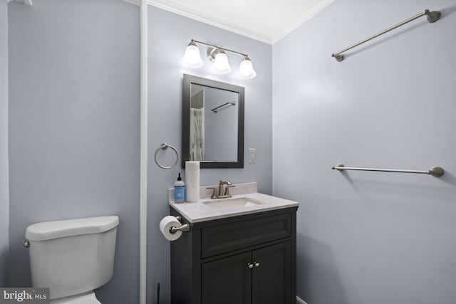 bathroom featuring crown molding, vanity, and toilet