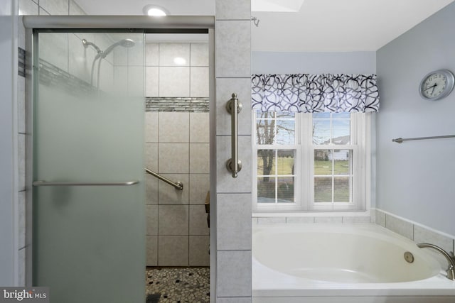 bathroom with shower with separate bathtub