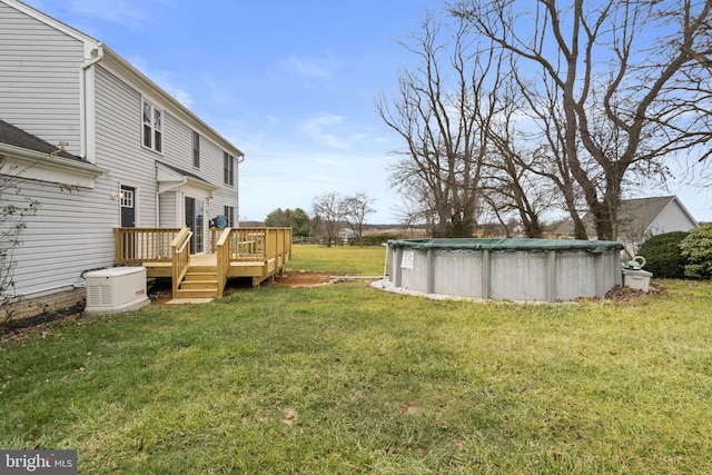 view of yard with a swimming pool side deck