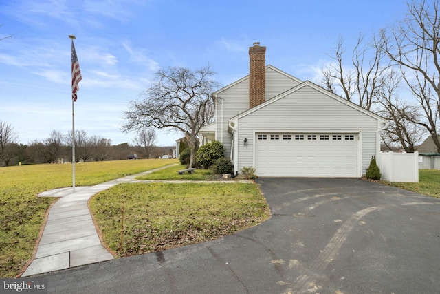 view of side of home with a garage and a lawn